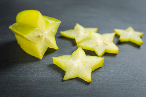 Sliced star fruit on a gray table