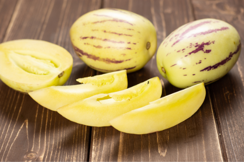 Sliced pepino melon displaying on a wooden table