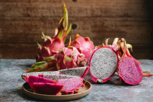 Sliced (purple) dragon fruit laying on a table