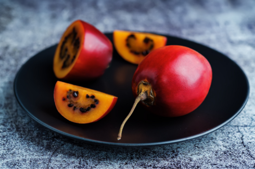 Sliced tamarillo fruit displaying on a gray table