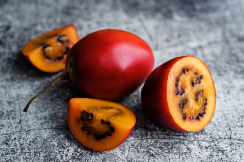 Sliced tamarillo fruit displaying on a gray table